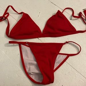 This bathing suit is from Frankie’s bikini. It’s red and size large.